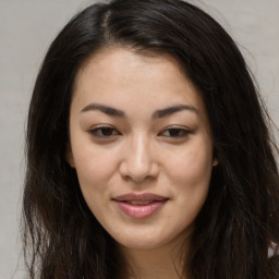 Joyful asian young-adult female with long  brown hair and brown eyes