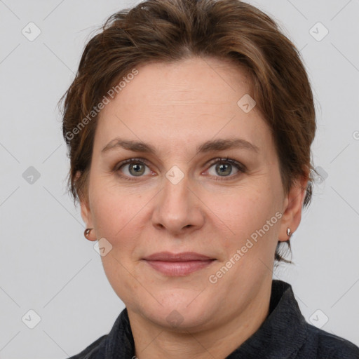 Joyful white adult female with short  brown hair and grey eyes