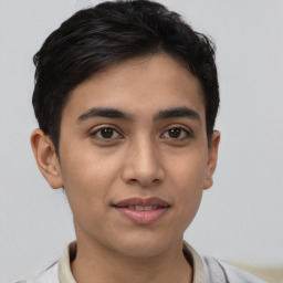 Joyful latino young-adult male with short  brown hair and brown eyes