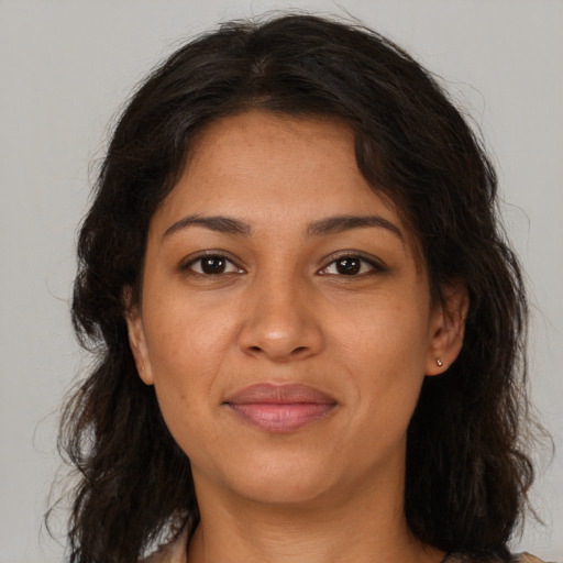 Joyful black young-adult female with long  brown hair and brown eyes