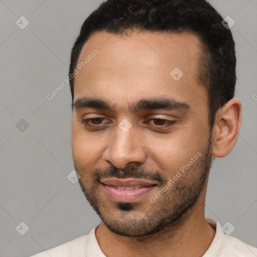 Joyful white young-adult male with short  black hair and brown eyes