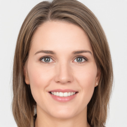 Joyful white young-adult female with long  brown hair and grey eyes