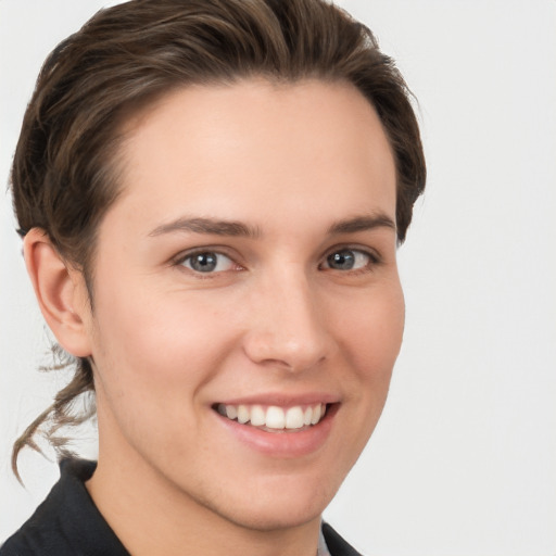 Joyful white young-adult female with short  brown hair and grey eyes