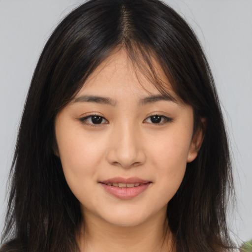 Joyful asian young-adult female with long  brown hair and brown eyes
