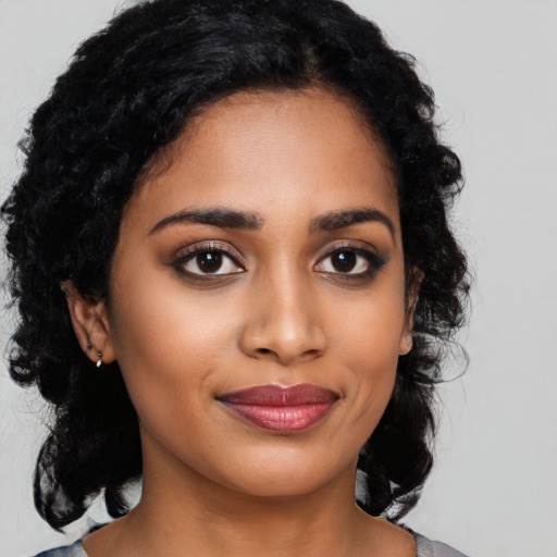 Joyful latino young-adult female with medium  black hair and brown eyes