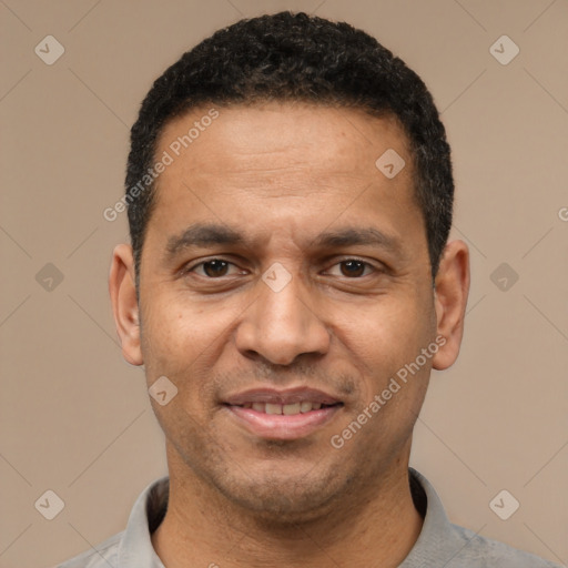 Joyful latino adult male with short  black hair and brown eyes