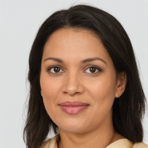 Joyful latino young-adult female with long  brown hair and brown eyes