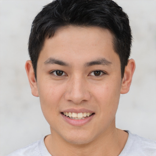 Joyful asian young-adult male with short  brown hair and brown eyes