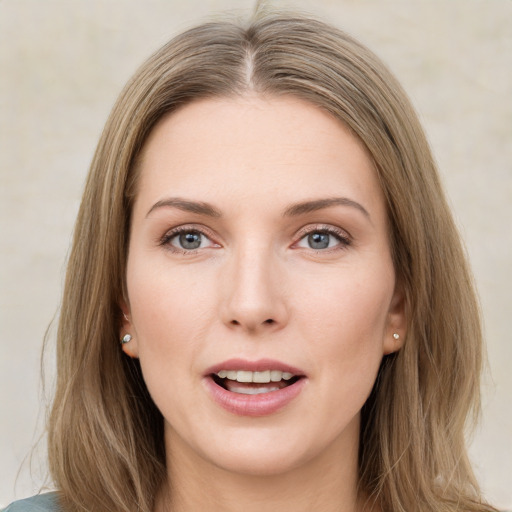 Joyful white young-adult female with long  brown hair and green eyes