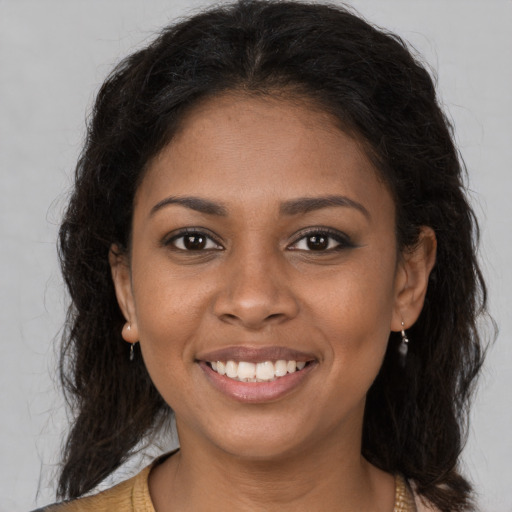 Joyful black young-adult female with medium  brown hair and brown eyes