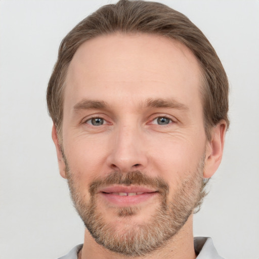 Joyful white adult male with short  brown hair and grey eyes