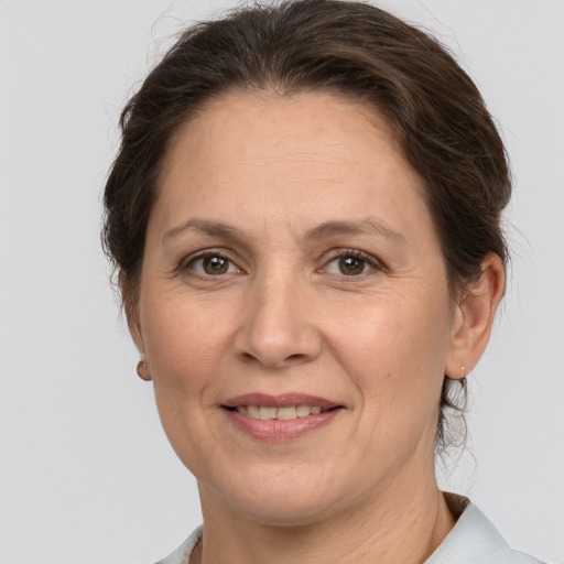 Joyful white adult female with short  brown hair and brown eyes