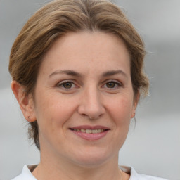 Joyful white adult female with medium  brown hair and grey eyes