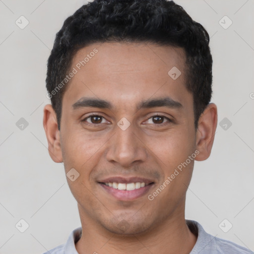 Joyful latino young-adult male with short  black hair and brown eyes