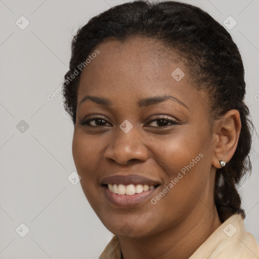 Joyful black young-adult female with long  brown hair and brown eyes