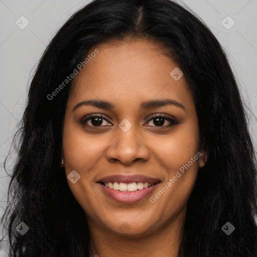 Joyful black young-adult female with long  black hair and brown eyes