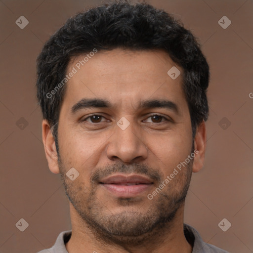 Joyful latino young-adult male with short  brown hair and brown eyes