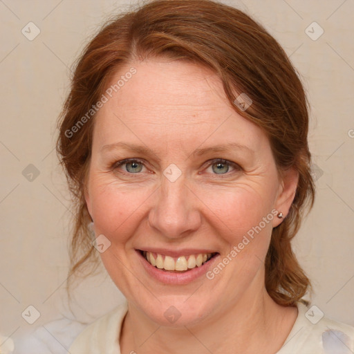 Joyful white adult female with medium  brown hair and blue eyes