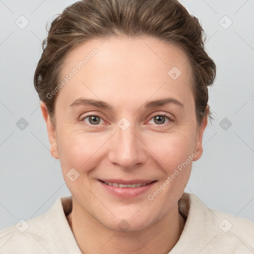 Joyful white young-adult female with short  brown hair and grey eyes