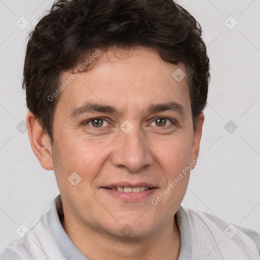 Joyful white adult male with short  brown hair and brown eyes