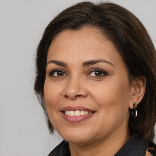 Joyful white adult female with medium  brown hair and brown eyes