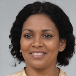 Joyful black adult female with medium  brown hair and brown eyes