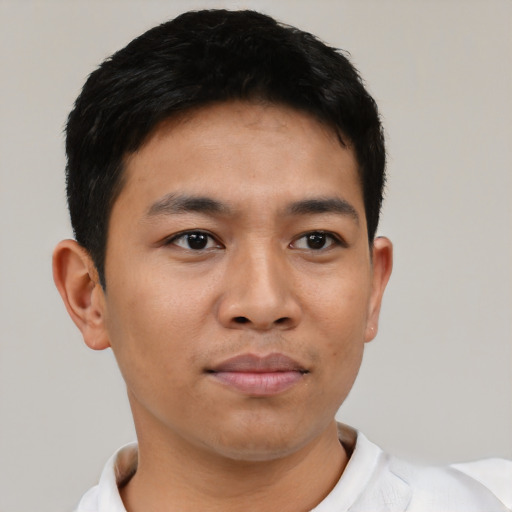 Joyful asian young-adult male with short  black hair and brown eyes