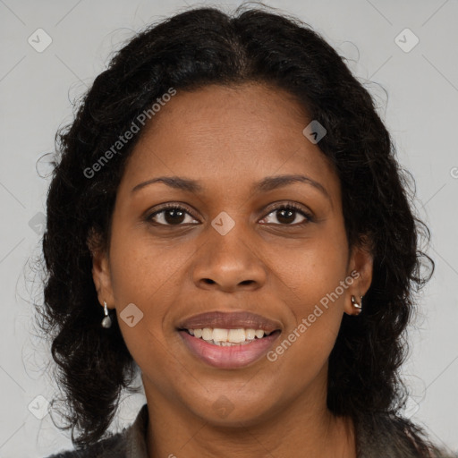 Joyful black young-adult female with long  brown hair and brown eyes