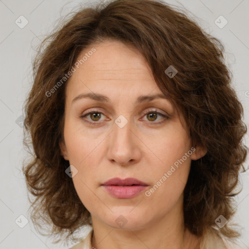 Joyful white adult female with medium  brown hair and green eyes