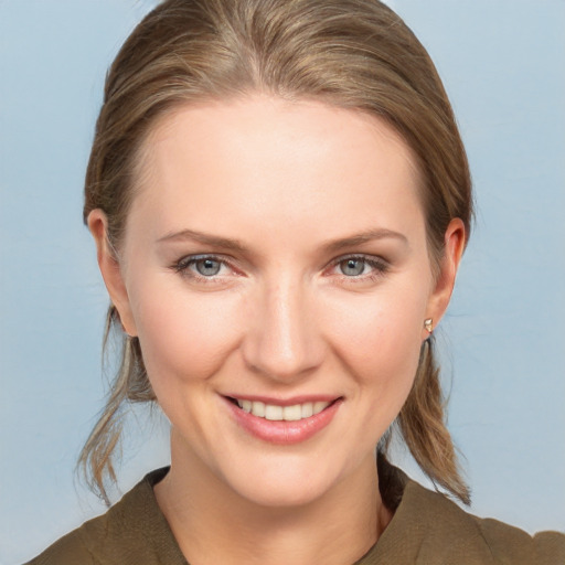 Joyful white young-adult female with medium  brown hair and grey eyes