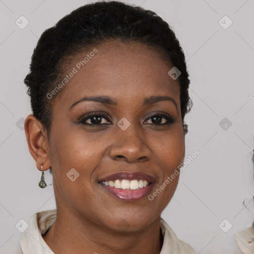 Joyful black young-adult female with short  brown hair and brown eyes