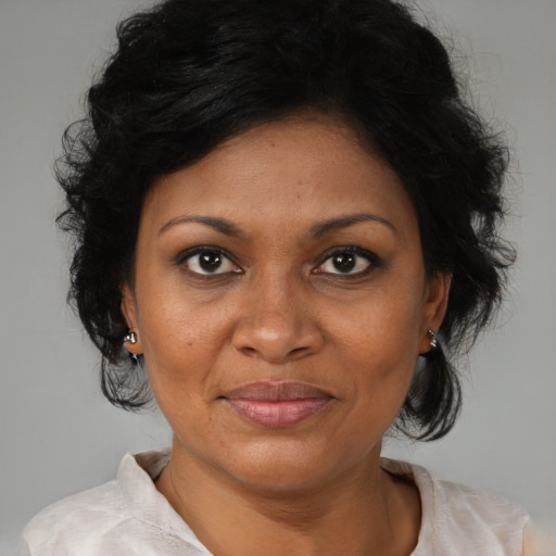 Joyful black adult female with medium  brown hair and brown eyes