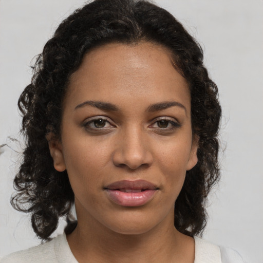 Joyful black young-adult female with medium  brown hair and brown eyes