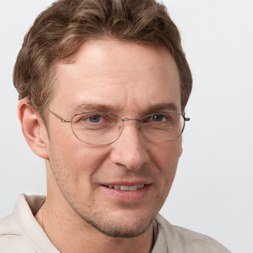 Joyful white adult male with short  brown hair and grey eyes