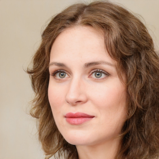 Joyful white young-adult female with medium  brown hair and green eyes