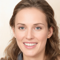 Joyful white young-adult female with long  brown hair and green eyes