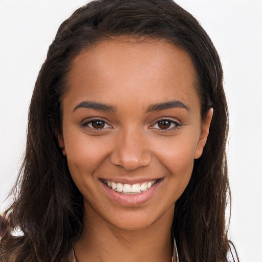 Joyful black young-adult female with long  brown hair and brown eyes