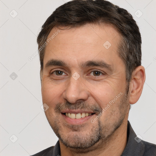 Joyful white adult male with short  brown hair and brown eyes