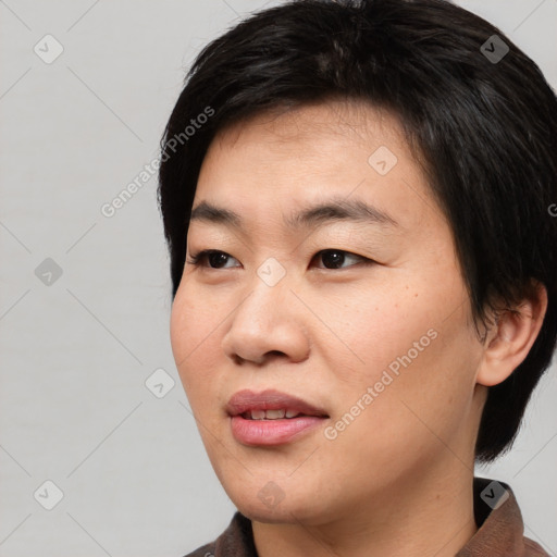 Joyful asian young-adult female with short  black hair and brown eyes