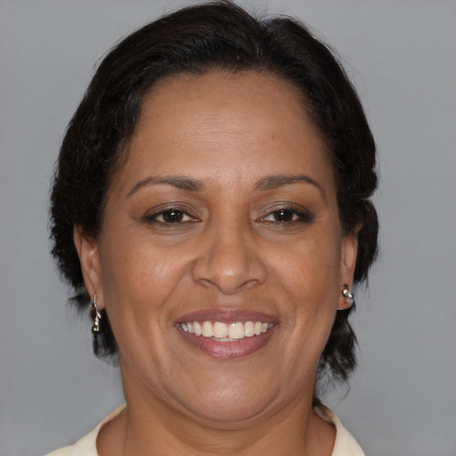 Joyful black adult female with medium  brown hair and brown eyes