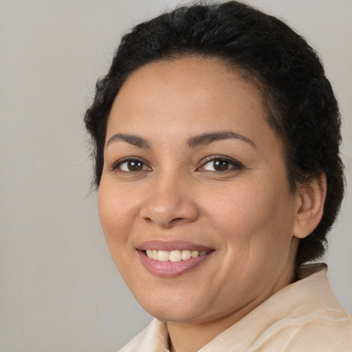 Joyful latino young-adult female with medium  brown hair and brown eyes