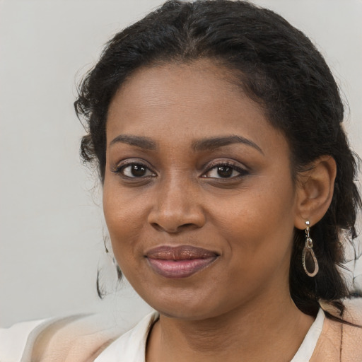 Joyful black young-adult female with long  brown hair and brown eyes