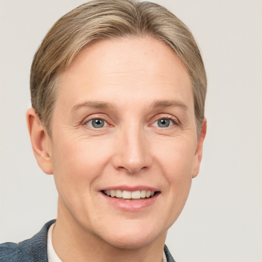 Joyful white adult female with short  brown hair and grey eyes