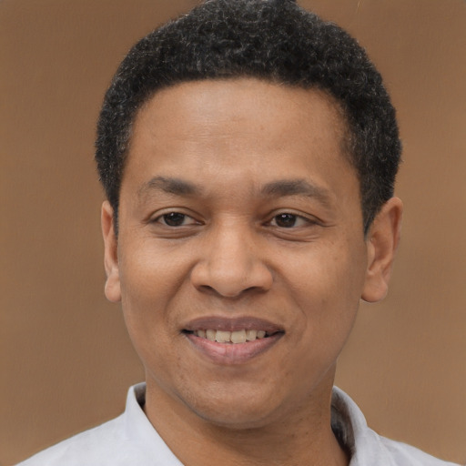 Joyful latino adult male with short  black hair and brown eyes