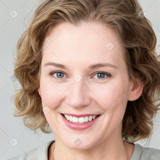 Joyful white young-adult female with medium  brown hair and blue eyes