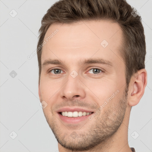 Joyful white young-adult male with short  brown hair and brown eyes