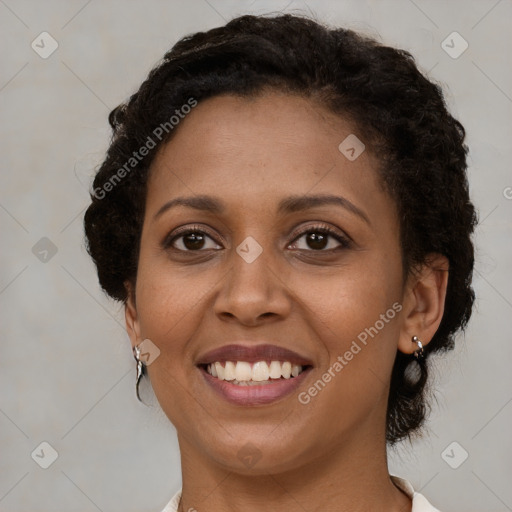 Joyful black young-adult female with short  brown hair and brown eyes