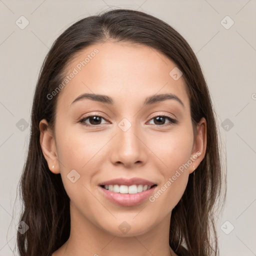 Joyful white young-adult female with long  brown hair and brown eyes