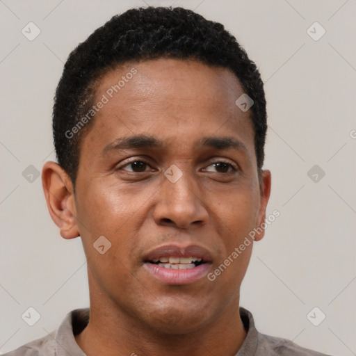 Joyful black adult male with short  brown hair and brown eyes