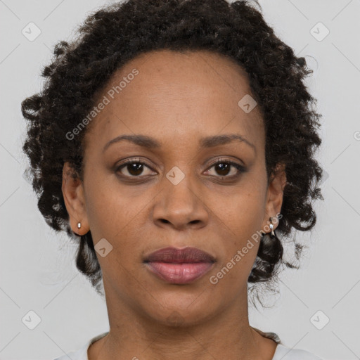 Joyful black adult female with short  brown hair and brown eyes